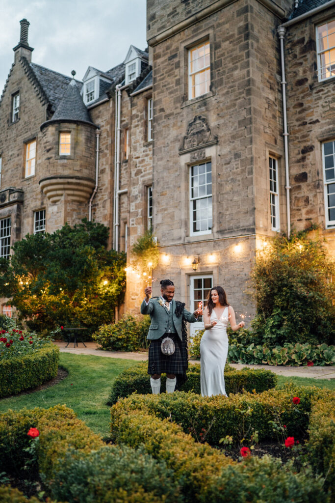 Bride and groom with sparklers at Carberry Tower wedding