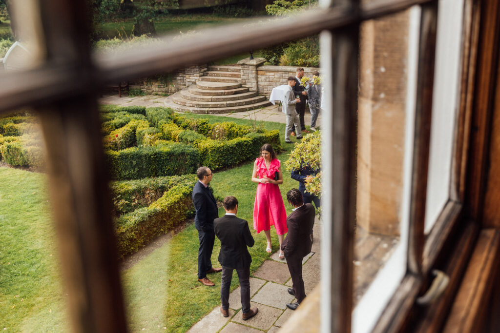 Carberry Tower wedding guests in the rose garden