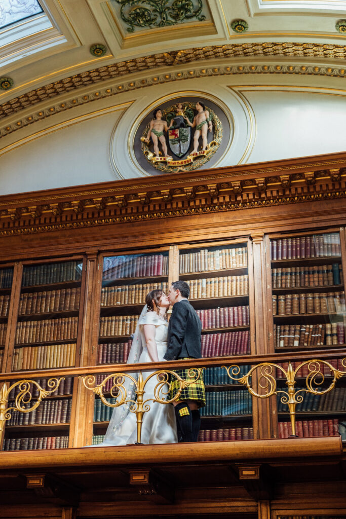 Bride and groom kiss at Royal College of Physicians Edinburgh